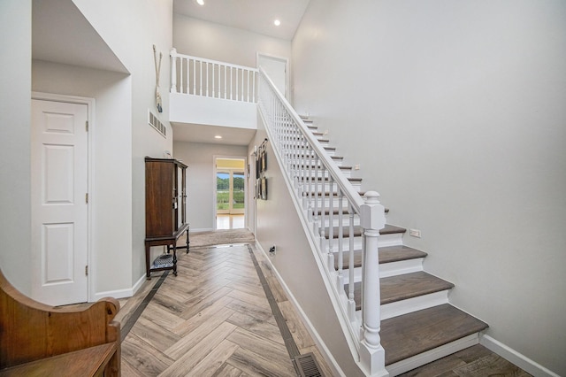 828 Russmiller Loop, Brooklyn, MI 49230 - stairs with baseboards and a towering ceiling