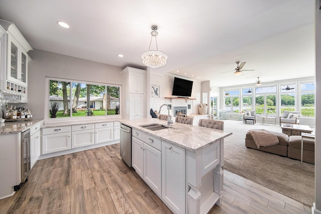 828 Russmiller Loop, Brooklyn, MI 49230 - kitchen featuring open floor plan, dishwasher, a fireplace, white cabinets, and ceiling fan