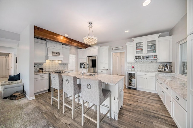 828 Russmiller Loop, Brooklyn, MI 49230 - kitchen featuring wine cooler, tasteful backsplash, white cabinets, premium range hood, and recessed lighting