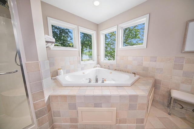 828 Russmiller Loop, Brooklyn, MI 49230 - bathroom with a tub with jets, a shower stall, recessed lighting, tile walls, and tile patterned flooring