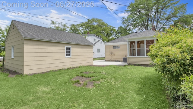 322 S Manitou Ave, Troy, MI 48017 - rear view of property with roof with shingles, a patio area, a lawn, and a sunroom