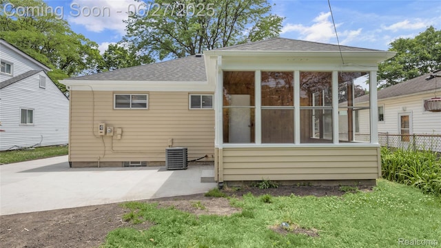 322 S Manitou Ave, Troy, MI 48017 - back of house with a shingled roof, a sunroom, and a patio area