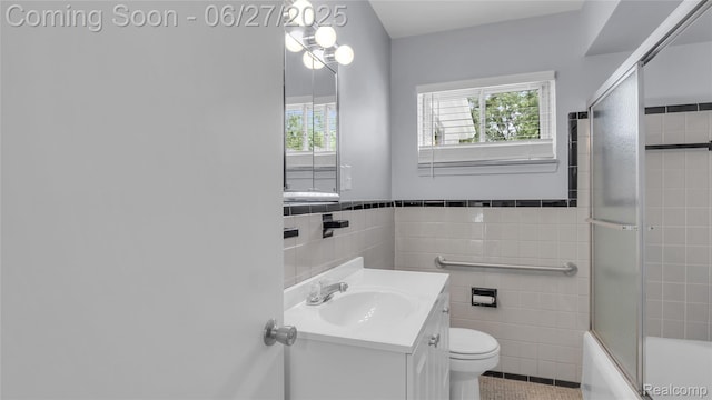 322 S Manitou Ave, Troy, MI 48017 - full bath with tile walls, tile patterned flooring, shower / bath combination with glass door, vanity, and wainscoting