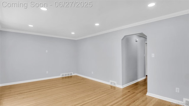 322 S Manitou Ave, Troy, MI 48017 - unfurnished room featuring arched walkways, ornamental molding, recessed lighting, and light wood-style floors