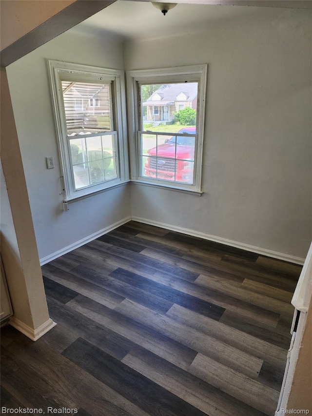 8428 Rosemont Ave, Dearborn Heights, MI 48228 - unfurnished dining area featuring dark wood-type flooring and baseboards