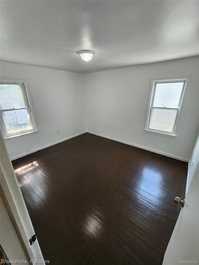 8428 Rosemont Ave, Dearborn Heights, MI 48228 - spare room with healthy amount of natural light and dark wood-type flooring