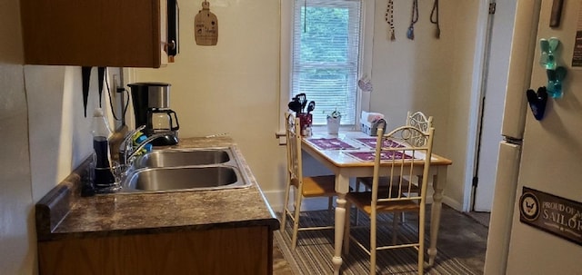 708 N Main St, Mount Pleasant, MI 48858 - kitchen featuring freestanding refrigerator and a sink