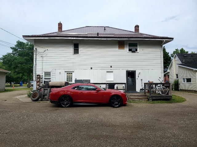 708 N Main St, Mount Pleasant, MI 48858 - rear view of house with a chimney and a metal roof