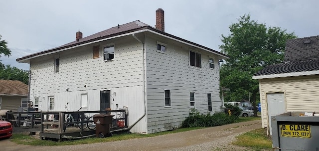 708 N Main St, Mount Pleasant, MI 48858 - view of side of property featuring a chimney