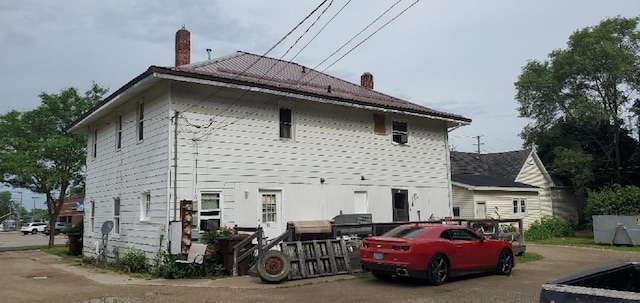 708 N Main St, Mount Pleasant, MI 48858 - rear view of house featuring a chimney