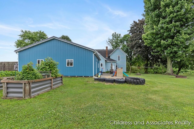 13872 Hastings Rd, Freeport, MI 49325 - rear view of house with a vegetable garden and board and batten siding