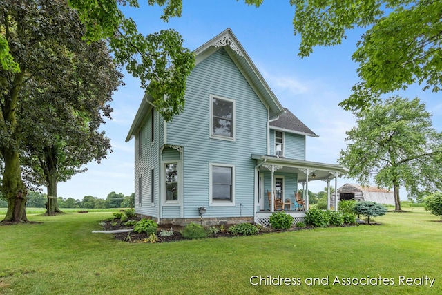 13872 Hastings Rd, Freeport, MI 49325 - rear view of property featuring a porch and a lawn