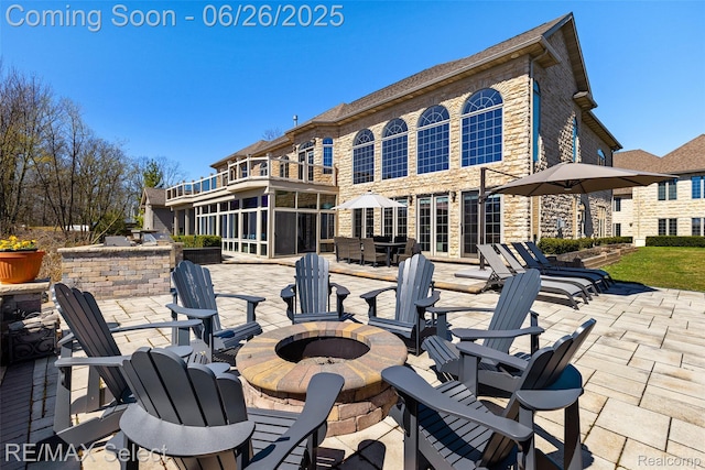 13229 Enid Blvd, Fenton, MI 48430 - patio / terrace with an outdoor fire pit, a patio, and a sunroom