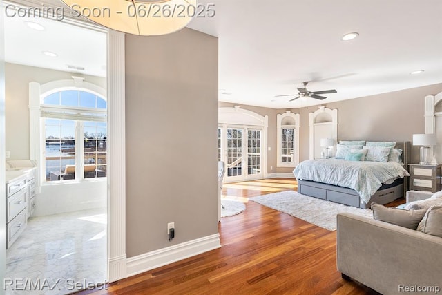 13229 Enid Blvd, Fenton, MI 48430 - bedroom with multiple windows, recessed lighting, wood finished floors, and arched walkways