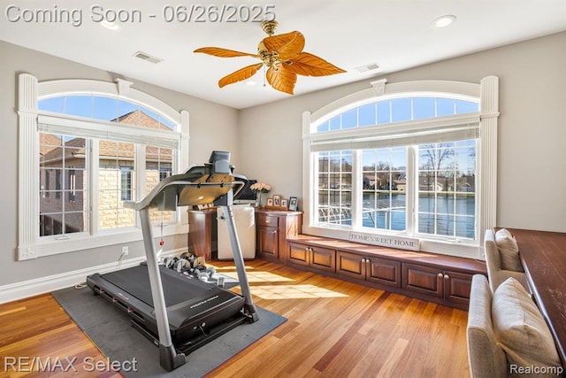 13229 Enid Blvd, Fenton, MI 48430 - exercise room featuring light wood-type flooring, a ceiling fan, recessed lighting, and a water view