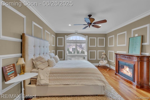 13229 Enid Blvd, Fenton, MI 48430 - bedroom featuring wood finished floors, a glass covered fireplace, crown molding, ceiling fan, and recessed lighting