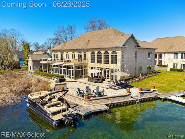 13229 Enid Blvd, Fenton, MI 48430 - back of house featuring a patio area, a water view, a lawn, and a balcony
