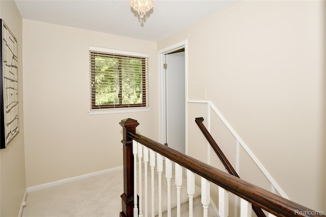 142 E Hickory Grove Rd Unit 3, Beverly Hills, MI 48304 - hall featuring an upstairs landing, carpet floors, and a chandelier