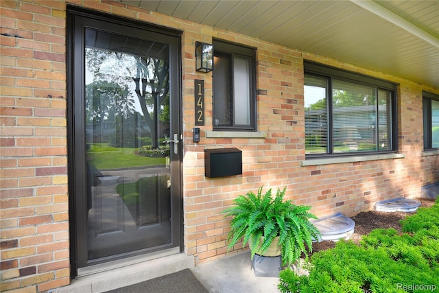 142 E Hickory Grove Rd Unit 3, Beverly Hills, MI 48304 - view of exterior entry with brick siding and covered porch