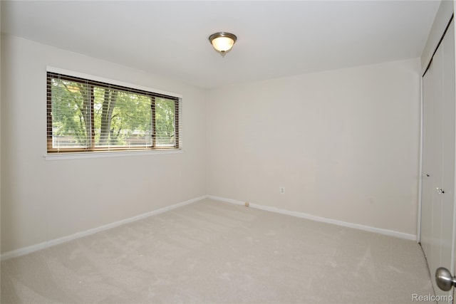 142 E Hickory Grove Rd Unit 3, Beverly Hills, MI 48304 - spare room featuring light colored carpet and baseboards