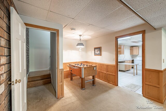 175 Honey Creek Ave NE, Ada, MI 49301 - game room with washer / dryer, a paneled ceiling, a wainscoted wall, and light colored carpet
