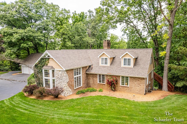 175 Honey Creek Ave NE, Ada, MI 49301 - view of front of house featuring a chimney, stairs, a shingled roof, and a front lawn
