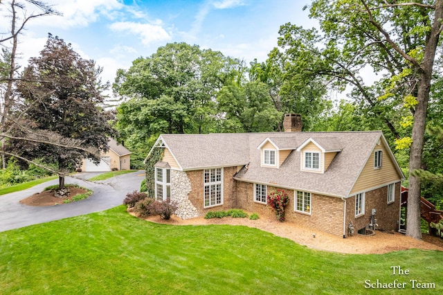 175 Honey Creek Ave NE, Ada, MI 49301 - view of front of home featuring a chimney, a front lawn, roof with shingles, and view of scattered trees