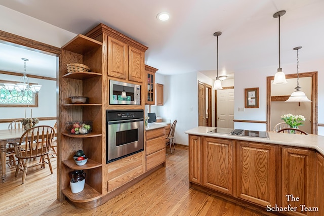 175 Honey Creek Ave NE, Ada, MI 49301 - kitchen with appliances with stainless steel finishes, open shelves, light wood-style flooring, brown cabinets, and light countertops