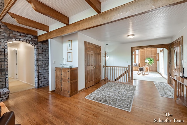 175 Honey Creek Ave NE, Ada, MI 49301 - entrance foyer with arched walkways, wood finished floors, beam ceiling, and ornate columns