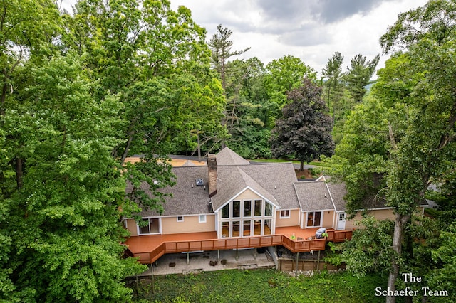 175 Honey Creek Ave NE, Ada, MI 49301 - rear view of house featuring a deck, a shingled roof, and stairs