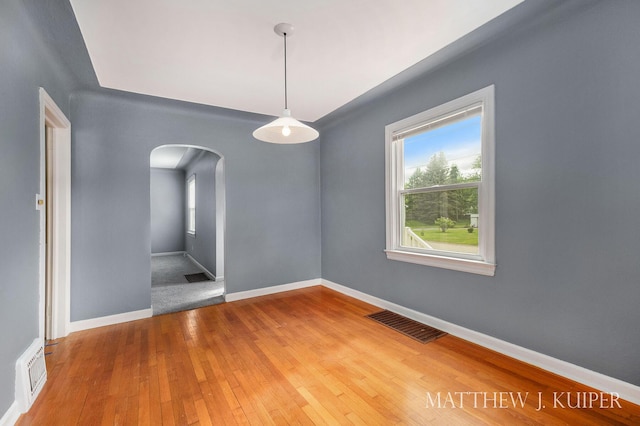 1512 Werner Ave NW, Grand Rapids, MI 49534 - spare room with arched walkways and wood-type flooring