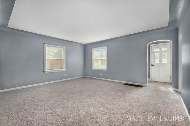 1512 Werner Ave NW, Grand Rapids, MI 49534 - carpeted spare room featuring baseboards and arched walkways