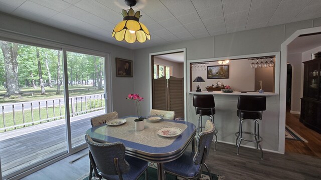 1686 Oak St, Wellston, MI 49689 - dining area featuring dark wood-style flooring, bar, and arched walkways