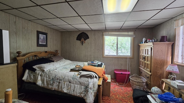 1686 Oak St, Wellston, MI 49689 - bedroom featuring multiple windows, a paneled ceiling, and wooden walls