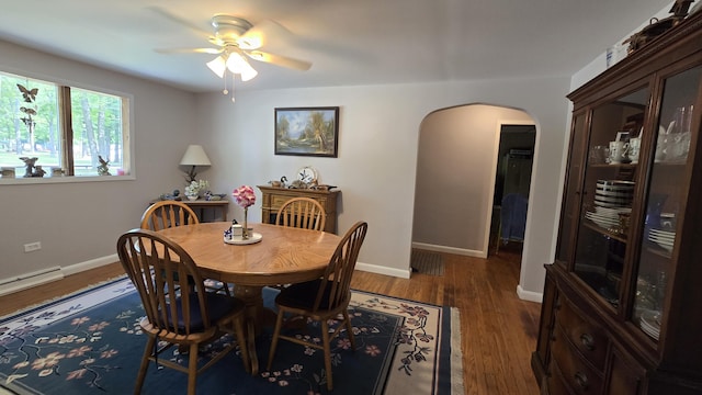 1686 Oak St, Wellston, MI 49689 - dining room with arched walkways, a ceiling fan, and wood finished floors