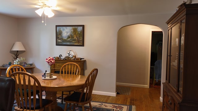 1686 Oak St, Wellston, MI 49689 - dining room featuring arched walkways, ceiling fan, and wood finished floors