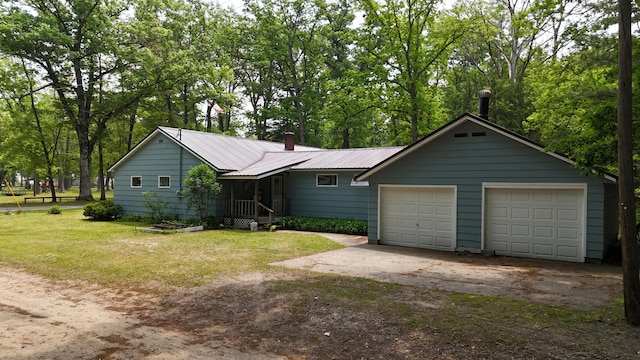 1686 Oak St, Wellston, MI 49689 - single story home featuring a metal roof, a chimney, a front yard, and view of wooded area