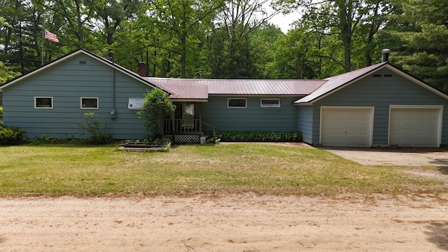 1686 Oak St, Wellston, MI 49689 - ranch-style house featuring a garage, a front yard, and a metal roof