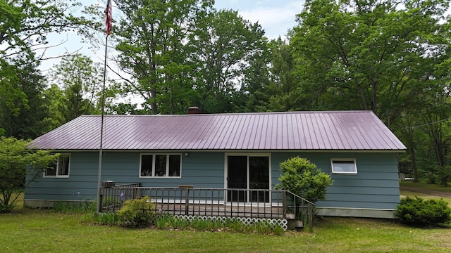 1686 Oak St, Wellston, MI 49689 - back of property with a metal roof and a lawn