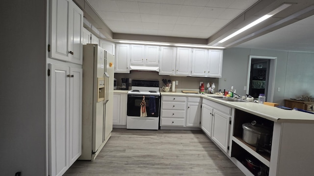 1686 Oak St, Wellston, MI 49689 - kitchen with white appliances, custom range hood, a peninsula, white cabinets, and light wood-style floors