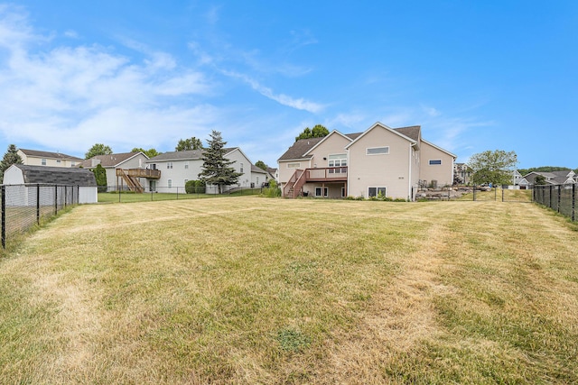 7068 Jasper Dr, Hudsonville, MI 49426 - rear view of house featuring a fenced backyard, stairway, a residential view, and a wooden deck
