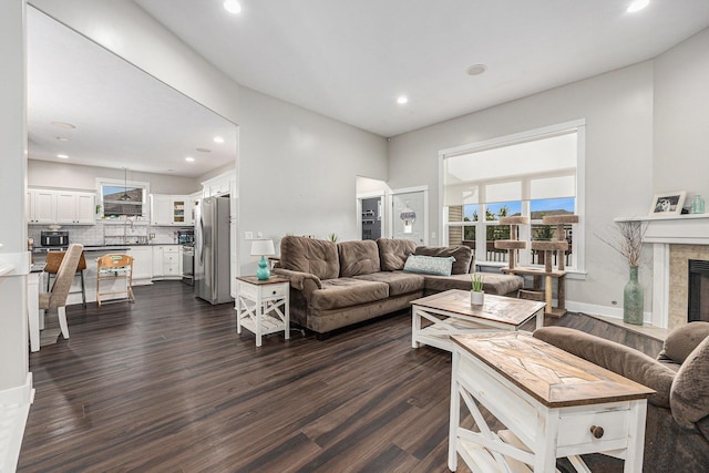 7068 Jasper Dr, Hudsonville, MI 49426 - living room featuring dark wood-style floors, recessed lighting, and a tiled fireplace