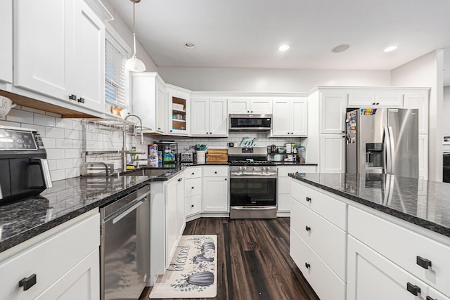 7068 Jasper Dr, Hudsonville, MI 49426 - kitchen featuring appliances with stainless steel finishes, white cabinets, dark wood-type flooring, backsplash, and hanging light fixtures