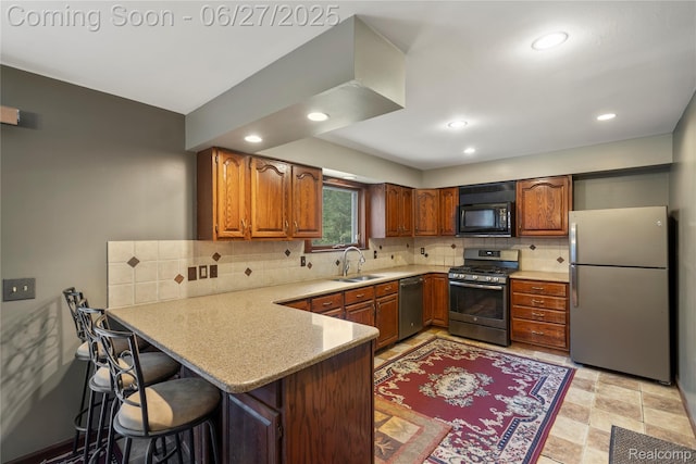 1500 Rustic Ln, Commerce Twp, MI 48390 - kitchen featuring appliances with stainless steel finishes, a peninsula, light countertops, brown cabinetry, and recessed lighting