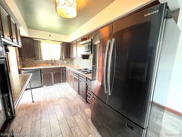 913 Cameron Ave, Pontiac, MI 48340 - kitchen with appliances with stainless steel finishes, light wood-type flooring, backsplash, and dark brown cabinets