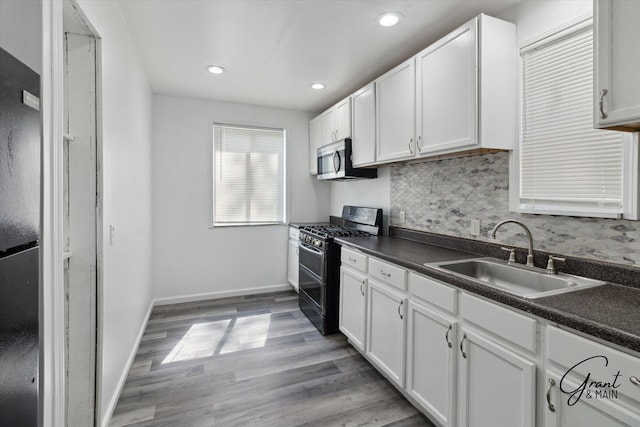 16630 Tracey St, Detroit, MI 48235 - kitchen with stainless steel appliances, dark countertops, white cabinets, and recessed lighting