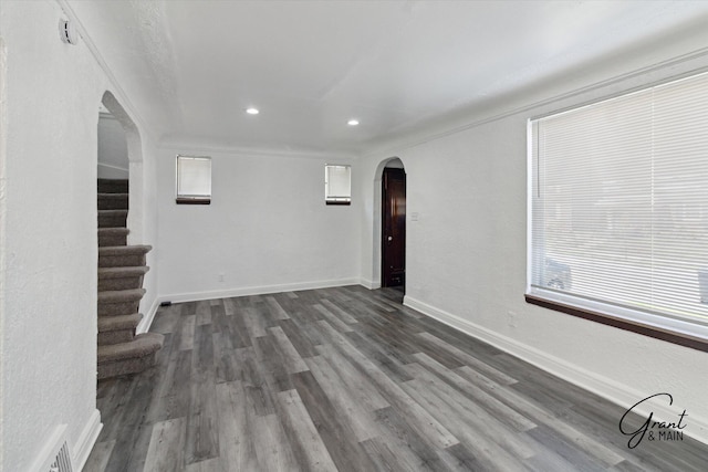 16630 Tracey St, Detroit, MI 48235 - unfurnished living room with arched walkways, recessed lighting, dark wood-type flooring, stairs, and ornamental molding