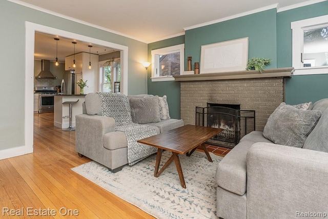 1388 W Troy St, Ferndale, MI 48220 - living room featuring light wood finished floors, ornamental molding, and a brick fireplace