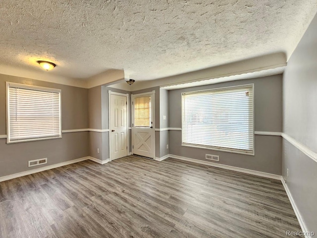 26495 Monticello St, Inkster, MI 48141 - unfurnished bedroom featuring a textured ceiling and wood finished floors