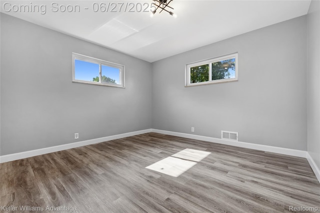 36669 Pinetree St, Livonia, MI 48150 - unfurnished room featuring plenty of natural light, wood finished floors, and a chandelier
